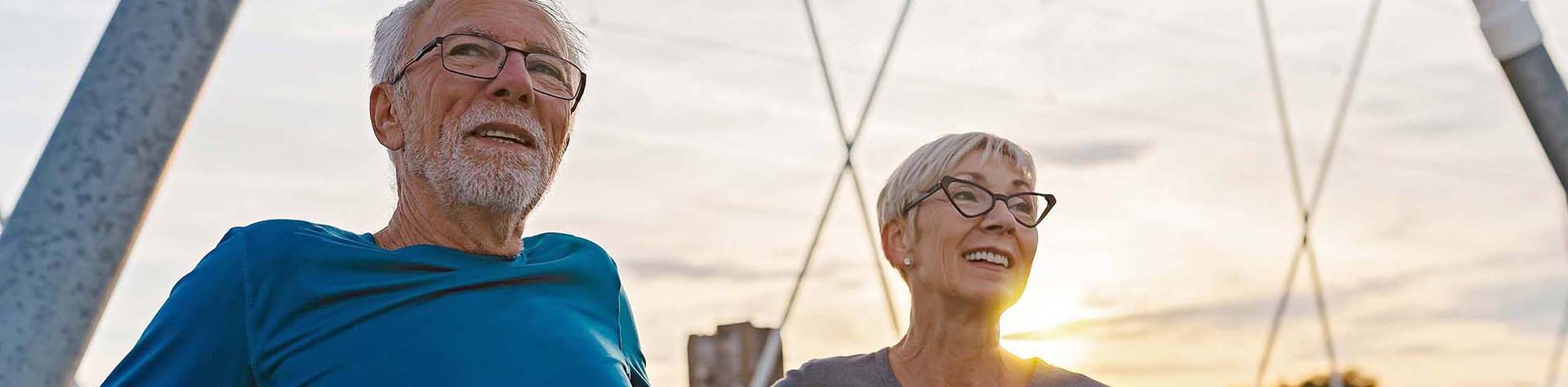 Portrait,Of,Cheerful,Active,Senior,Couple,Standing,On,The,Bridge,